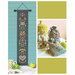 The Folk Flowers cross stitch finished as a banner next to three drawstring bags with a few of the flower motifs from the pattern