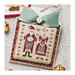 Finished Mr. & Mrs. Claus cross stitch pattern on an ornament topped with a bow surrounded by Christmas bells.