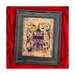 Finished Haunted Forrest cross stitch pattern of a haunted house in a forest with Halloween motifs inside of a black wood frame hung on a red velvet