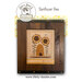 Front cover of the finished Sunflower Bee cross stitch pattern with sunflowers surrounding a bee hive with a bee flying about in a dark wooden frame.