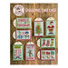 Front cover of the finished Christmas Tiny Tags cross stitch project with all sorts of Christmas motifs and phrases laid out on a wood plank backdrop.