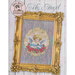 Front cover of the finished My Angel pattern of an angel inside of an ornamental gold and rose border on a striped fabric framed by an ornate gold frame.