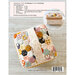 The top of an alternate stitching style for the Cutie Cube Bag with a supporting photo of a front shot of the bag layered on top of a table with the required fabrics and materials.