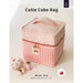 Angled front shot of the Cutie Cube Bag with a spool of thread filled with pins next to a cat pin cushion.