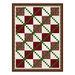 Red and white blocks with a green lattice designed Christmas quilt.