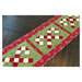Candy Cane Lane table runner pattern with the runner in green and red hanging off the edge of a wooden table.