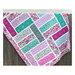 Finished The Big Easy pattern with purple and teal tone fabrics hung on a wooden fence.