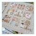 Finished The Spring Diary cross stitch pattern on a gray fabric at a biased angle.