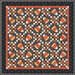 Patchwork quilt with repeating autumn-colored triangular motifs and a dark border.