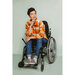 Model wearing the regular length Ilford jacket in an orange-plaid fabric design, blue jeans, sitting in a wheelchair.