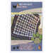 The front of the Ella's Attic pattern with the completed quilt displayed hanging over a fence.