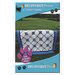 The front of the Connections pattern with the completed quilt displayed hanging over a fence.