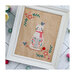 Finished Stitching Friends cross stitch pattern on a white wooden background surrounded by wool balls.Stitching Friends cross stitch pattern on a white wooden background surrounded by wool balls.