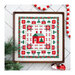 Finished Holly Lane cross stitch pattern in a wooden frame on white herringbone planks surrounded by Christmas motifs.