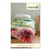 The front of the Starflake Quilt Pattern, showing the finished quilt draped over a bed.