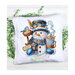 Mock-up of the finished Christmas Cheer cross stitch pattern of a cheerful snowman with a mug of cocoa wearing winter attire surrounded by birds on a white pillow.