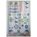The finished quilting featuring blue, green, and pink, equestrian themed motifs on a white background.