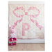 A version of the finished project quilt featuring a pink bow and the letter P on a white background.