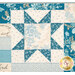 A close up on a patchwork star of the quilt, showing details on the fabric prints and colors.