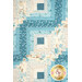 A close up on the patchwork of the quilt, demonstrating fabric prints and color details.