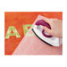 A model using an iron to press on the Wonder Fuse onto the fabric.