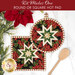 The two completed Folded Star Hot Pads colored in red, green, and white fabrics from the Poinsettias at Christmas collection by Jennifer Bosworth for Riley Blake Designs, one round and one square, slightly overlapping each other and staged on a white table with coordinating décor.