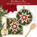 The two completed Folded Star Hot Pads colored in red, green, and white fabrics from the Poinsettias at Christmas collection by Jennifer Bosworth for Riley Blake Designs, one round and one square, slightly overlapping each other and staged on a white table with coordinating décor.