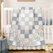 The completed quilt, artfully draped over the side of a white crib with coordinating bedding and décor.