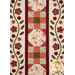 A head on shot of the quilt, demonstrating layout details on two appliqué rows and one patchwork row.