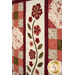 A close up on the quilt, showing details on the appliqué flowers and patchwork rows of the quilt.