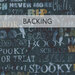 A dark blue fabric with fun typography of Halloween words and motifs; a transparent banner at the top reads "Backing." 