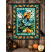 The completed Ribbon Border Panel Quilt, colored in moody teal, green, navy, and orange fabrics from the Raven's Call collection by Northcott Fabrics, staged on a rustic wood barn interior wall, staged with coordinating lanterns, pumpkins, and crows.