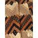 An angled close up on the draped quilt, demonstrating fabric color and print details.