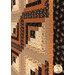 An angled close up on the quilt, demonstrating fabric color and print details.