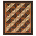 The completed Log Cabin Throw Quilt, colored in black, brown, tan, orange, and cream fabrics from the Midnight Cheddar collection from Marcus Fabrics, isolated on a white background. 