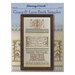 Front cover of the Grace & Love Birth Sampler with the finished design in a wooden frame isolated on an enlarged photo of the pattern.