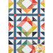 A head on close up on the quilt, demonstrating patchwork layout details and fabric colors and prints.