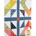 A super close up on the quilt, demonstrating patchwork layout details and fabric colors and prints.