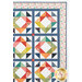 A close up on the upper right corner of the quilt, demonstrating patchwork layout details on the diamond blocks, borders, and binding.