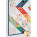 A close up on the wall hanging, demonstrating fabric prints and color details.
