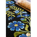 A close up on the runner, demonstrating fabric colors and details on the appliqué florals and leaves. 