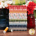 A stack of the fabrics included in the Magic Stripe collection, with flowers and vaes and thread and a window