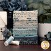 A stack of the fabrics included in the La Maison Bleu collection, with plants and flowers and a ceramic house and thread.
