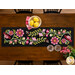 A top down shot of the runner, showing layout details on the appliqué florals, leaves, and vines.