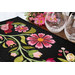A close up on the runner, demonstrating fabric colors and details on the appliqué florals and leaves. 