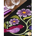 A super close up on the appliqué of the runner, demonstrating fabric colors and topstitching details on the flowers, leaves, and bird.