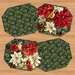 Four panel placemats in sophisticated poinsettia fabrics on a wooden tabletop background.