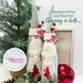 Two completed hand-dyed wool and felt folk Santa figurines staged with holiday décor.