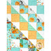 A head-on close up of the quilt, showing details on the patchwork as well as the fabric colors and prints.