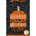 A close up on a patchwork pumpkin, showing details on the patchwork as well as fabric colors and prints.